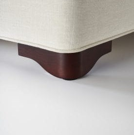 Close-up of a wooden furniture leg on a white background