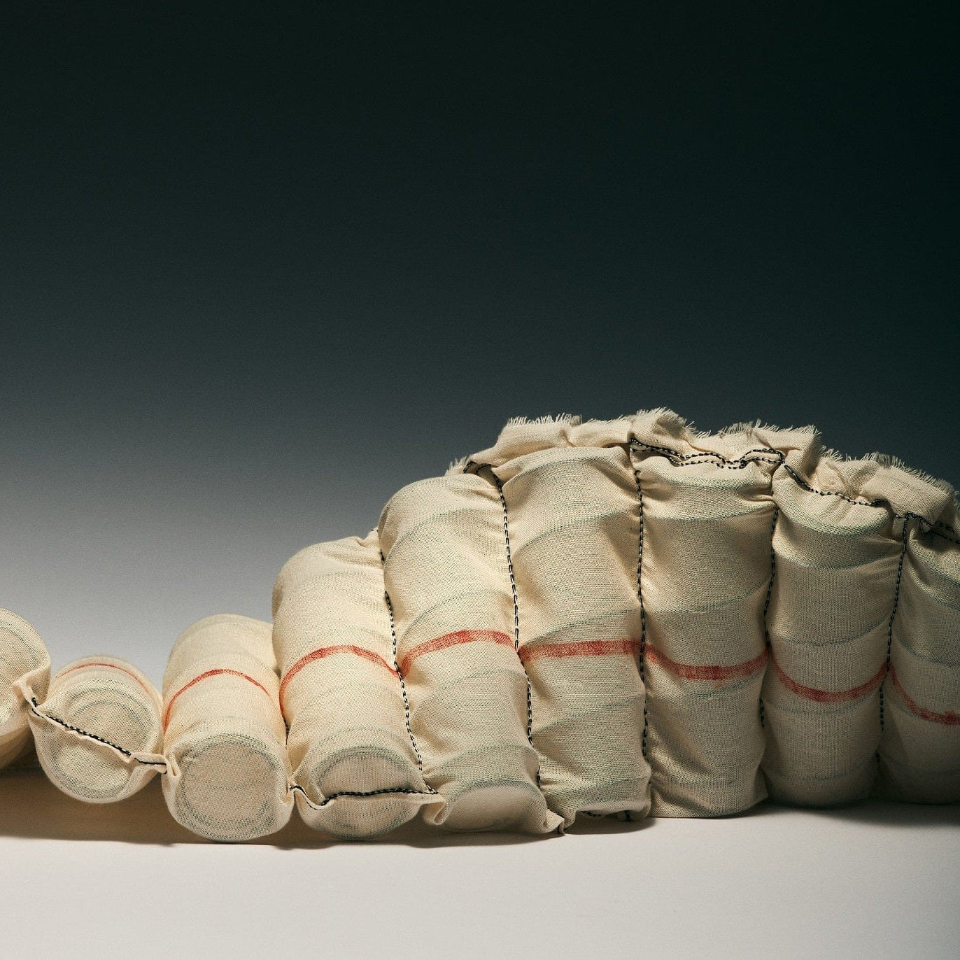 Bundles of fabric tied together on a gradient background